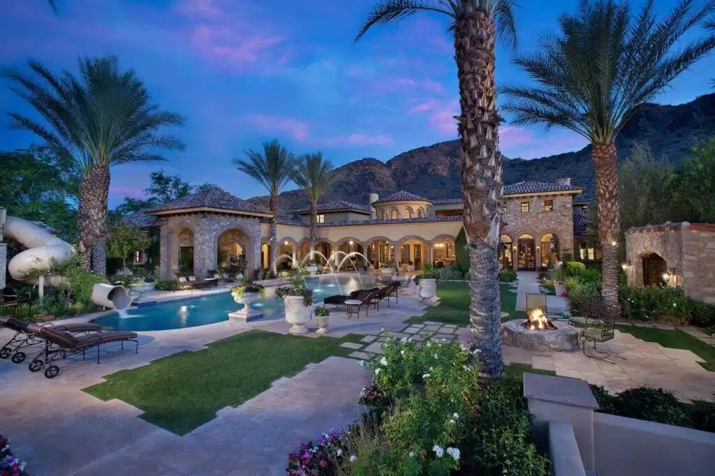 A desert modern home, glass walls open to the terrace