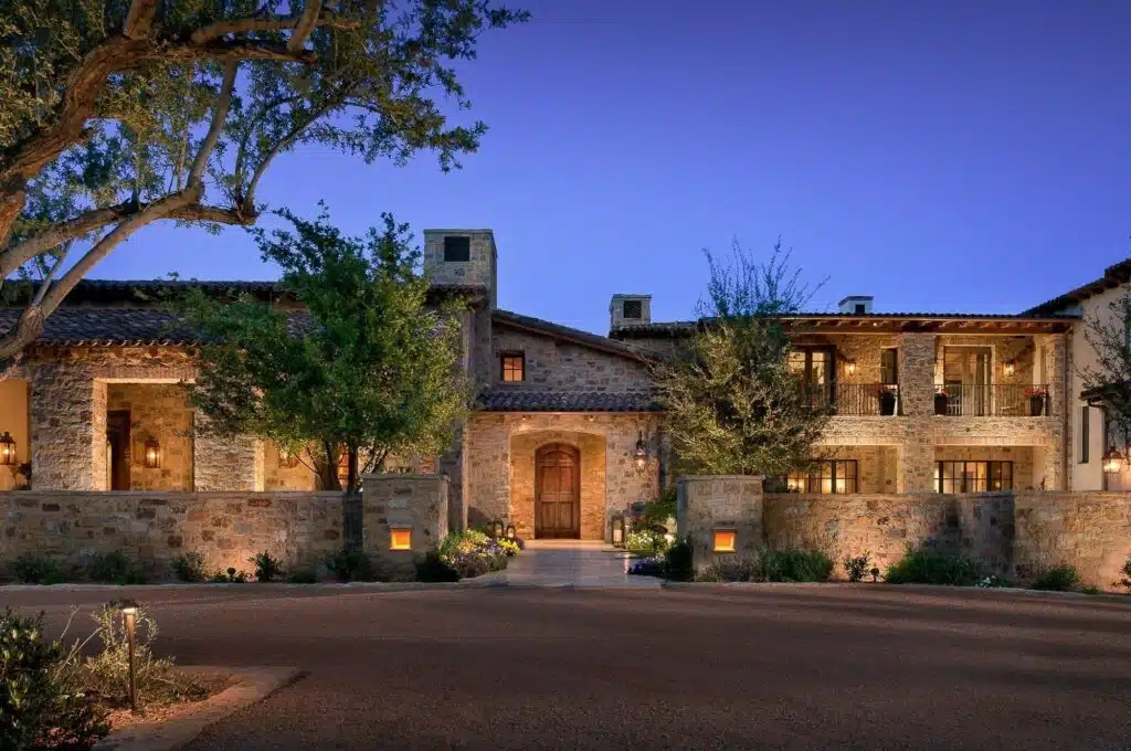 A poolside elevation at dusk by Desert Star Construction